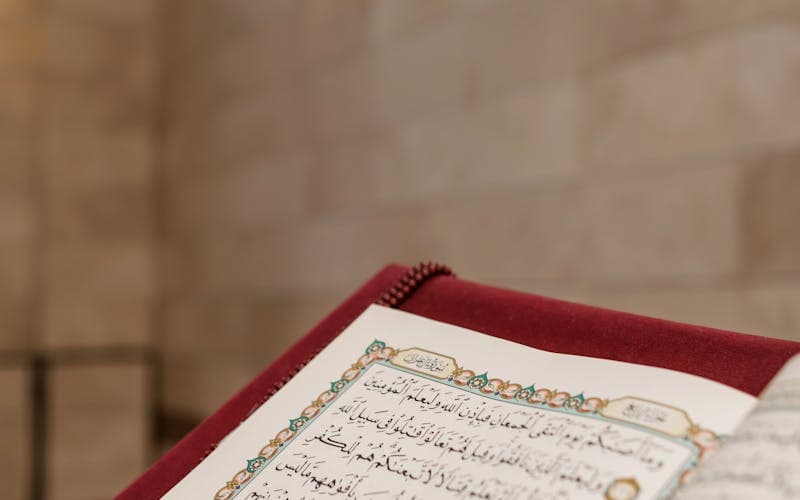 Close-up of an open Quran book